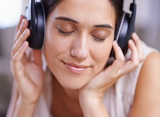 Image showing Calm woman, headphones and listening to music with smile on sofa for free time, comfort or relaxing at home. Female face smiling on living room couch with headset for audio sound track or relaxation