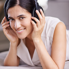 Image showing Happy woman, face and headphones listening to music with smile on sofa for free time, comfort or relaxing at home. Portrait of female smiling on living room couch with headset for audio sound track