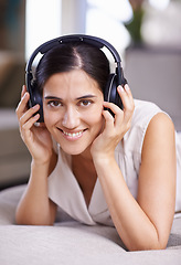 Image showing Happy woman, portrait smile and headphones for music listening, free time or relaxing on sofa at home. Face of female smiling in happiness on living room couch with headset for audio sound track