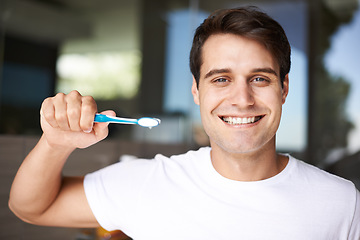 Image showing Brushing teeth, man portrait and cleaning in a bathroom at home for oral hygiene and health. Smile, dental and toothbrush with a male person with happiness in the morning at a house with care