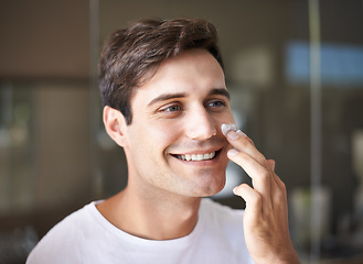 Image showing Beauty, skincare and face of man with cream in bathroom for facial treatment, wellness and grooming. Dermatology, healthy skin and happy male person with lotion, creme and moisturizer for hygiene