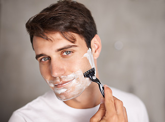 Image showing Foam, shaving and portrait of man in bathroom for facial grooming, wellness and skincare at home. Health, cosmetics and male person shave beard for face hygiene, cleaning and hair removal with razor