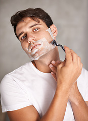 Image showing Cleaning, shaving and portrait of man in bathroom for facial grooming, wellness and cosmetics at home. Health, skincare and male person shave for face hygiene, self care and hair removal with razor
