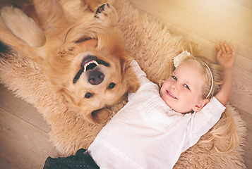 Image showing Girl, dog and portrait together on floor in living room or golden retriever, kid and smiling with pet above lounge carpet. Young child, Labrador and happiness or family home, pets and top view