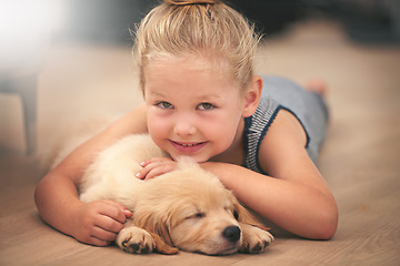 Image showing Girl hug her puppy in portrait, relax at home and happy with sleeping golden retriever and child with smile. Happiness, pet care and love with female kid with her domestic animal lying on wood floor