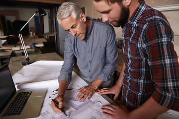 Image showing Architect men, teamwork and drawing blueprint with discussion, construction goal or vision in workshop. Senior man, young male partner and paperwork for building, property or real estate development