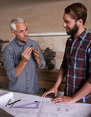 Image showing Architecture team, working on blueprint in workshop, designer and engineering collaboration. Senior mentor, male training architect and work together on remodeling project with floor plan paperwork