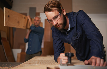 Image showing Carpentry collaboration, carpenter and men work in workshop on design project with vocation and creative skill. Teamwork, male worker cutting wood with power tools and father and son working together