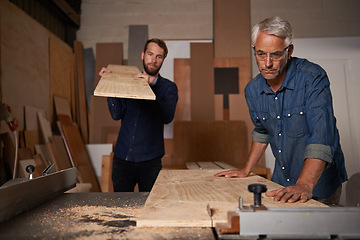 Image showing Carpentry, carpenter and men in workshop work on design project with team, vocation and creative DIY skill. Teamwork, collaboration and male employee saw wood with father and son working together