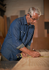 Image showing Carpentry, measuring tape and man with pencil, wood and designer furniture manufacturing workshop. Creativity, small business and professional carpenter working on sustainable wooden project design.