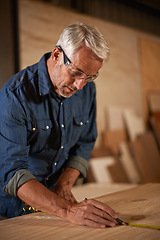 Image showing Carpentry, measuring tape and man with pencil, focus and designer furniture manufacturing workshop. Creativity, small business and professional carpenter planning sustainable diy wood project design.