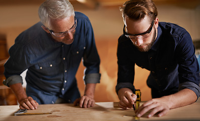 Image showing Teamwork, carpenter and apprentice in workshop, wood measurement and designer furniture manufacturing. Mentorship, carpentry and men at sustainable business, teaching and learning with design project