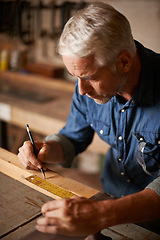 Image showing Carpentry, woodwork and man with pencil, ruler and designer furniture manufacturing workshop. Creativity, small business and focus, professional carpenter planning sustainable wood project design.
