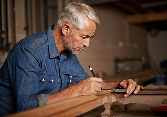 Image showing Carpentry, focus and man with pencil, table and creative work at furniture manufacturing workshop. Creativity, small business and professional carpenter working on sustainable wood project design.