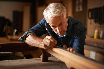 Image showing Carpentry, furniture restoration and man with pencil, table and antique wood manufacturing workshop. Creativity, small business and focus, professional carpenter working on retro wood project design.