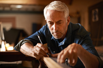 Image showing Furniture restoration, pencil and carpenter man in antique table manufacturing workshop with focus. Concentration, small business and expert carpentry, woodwork for sustainable wood project design.