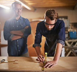 Image showing Mentor carpenter, apprentice and wood measurement at designer furniture manufacturing workshop. Proud mentorship, carpentry and men at sustainable business, teaching and learning with design project.