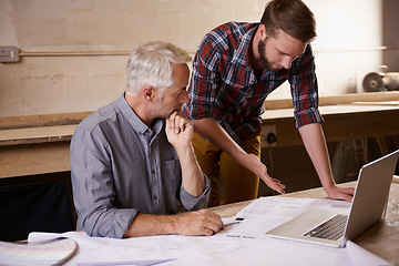 Image showing Architecture, collaboration and father and son with blueprint in workshop for building construction on laptop. Senior engineer, men and paperwork of trainee or apprentice working on design and plan.