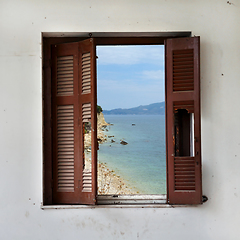 Image showing beach landscape through broken window
