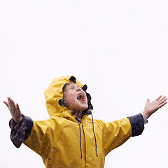 Image showing Girl child, rain and playing with space for mockup with shouting, happiness or winter fashion. Female kid, raincoat or playful with water, open hands or screaming on adventure with freedom in mock up