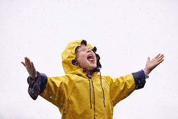 Image showing Girl outdoor, rain and playing in space for mockup with tongue, happiness or winter fashion. Female child, raincoat or play with water, open palm or excited face on adventure with freedom in mock up