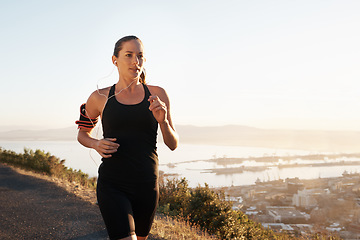 Image showing Running, street and woman training, workout and fitness with freedom, view and balance outdoor. Female person, lady and athlete with a healthy lifestyle, runner and exercise with wellness and cardio