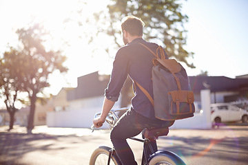 Image showing Bicycle, transport and man cycling in road with lens flare for exercise, commute and riding in morning. Travel, city and male cyclist on bike for eco friendly traveling, carbon neutral and journey