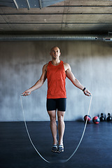 Image showing Keep it going. Fitness, jump rope and portrait of man doing gym training, cardio endurance challenge or exercise performance. Skipping, active lifestyle and male sports person doing jumping workout.