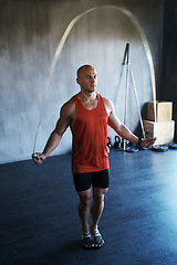 Image showing Fitness health, jump rope and man doing gym training, cardio endurance challenge or exercise performance. Skipping, commitment and healthy sports person, male athlete or guy doing jumping workout