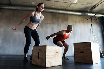 Image showing Gym, couple and exercise with box jump for training, workout and intense cardio on wall background. Health, fitness and people at a sports center for wellness, performance and endurance challenge