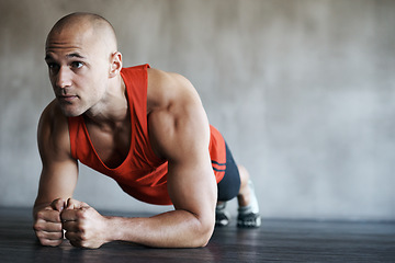 Image showing Fitness, man and plank in workout, exercise or training for strong core, abs or determination at gym. Serious, fit and confident male personal trainer working on abdominal muscle for healthy wellness