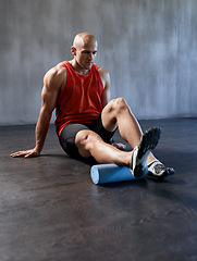 Image showing Fitness, foam roller or man stretching legs on floor for gym workout, healthy lifestyle or athlete pain relief. Health wellness massage, muscle warm up or relax person start exercise training routine