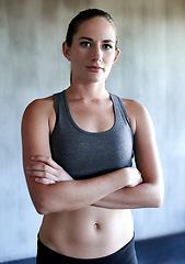 Image showing Workout, arms crossed and portrait of woman confident after health club exercise, fitness studio performance or gym training. Athlete lifestyle, motivation and healthy female person with confidence