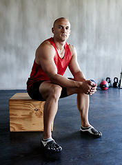 Image showing Exercise, serious and portrait of man sitting after bodybuilding workout, sports performance or gym studio commitment. Active, bodybuilder focus and healthy person with fitness progress determination