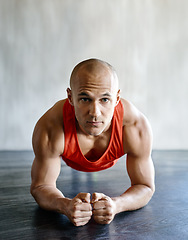 Image showing Gym floor, portrait and fitness man focus on plank exercise, health motivation or core strength building for bodybuilding. Training, hard work commitment and person doing muscle development workout