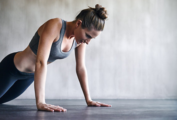 Image showing Workout, gym and woman doing floor push up for exercise, health commitment and training for muscle building growth. Fitness mockup, healthy lifestyle and female athlete focus on health performance