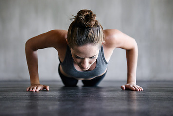 Image showing Training, push up and woman on a floor for fitness, cardio and endurance at gym. Plank, exercise and female athlete at a health center for core, strength and ground workout with determined mindset