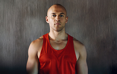 Image showing Workout, serious and portrait of man confident with determined mindset, gym commitment or discipline. Athlete focus, bodybuilder confidence and healthy fitness person on concrete wall background