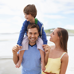 Image showing Family, portrait and fun while together at beach for travel holiday in summer with a smile. Man, woman and child or son walking outdoor on vacation or adventure at sea with happiness, love and care