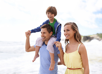 Image showing Family, fun and happy while walking at beach for travel, fun or holiday in summer with a smile. Man, woman and child or son walk together outdoor on vacation at sea with happiness, love and care