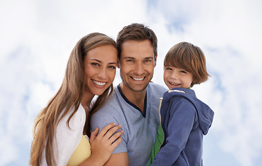 Image showing Blue sky, family and child portrait outdoor with a smile for travel, adventure or holiday in summer. A man, woman and kid or son together on vacation at the beach with love, parents and happiness