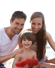 Image showing Family, watermelon and summer portrait at beach on travel holiday with a smile and fun. Man, woman and kid eating fruit and together on vacation at sea with love, care and happiness outdoor in nature