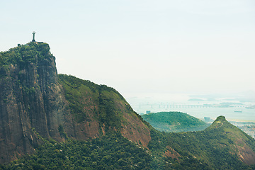 Image showing Mountain, nature and Christ the Redeemer in Brazil for tourism, sightseeing and travel destination. Landscape, Rio de Janeiro and drone view of statue, sculpture and landmark on hill background