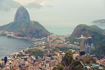 Image showing Brazil, monument and Christ the Redeemer in city on hill for tourism, sightseeing and travel destination. Traveling, Rio de Janeiro and aerial view of statue, sculpture and landmark on mountain