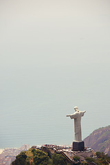 Image showing Brazil, monument and Christ the Redeemer by ocean for tourism, sightseeing and travel destination. Landscape, Rio de Janeiro mockup and aerial view of statue, sculpture and landmark on mountain