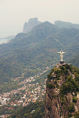 Image showing Brazil, statue and aerial of Christ the Redeemer on mountain for tourism, sightseeing and travel destination. Traveling, Rio de Janeiro and drone view of monument, sculpture and city mockup on hill