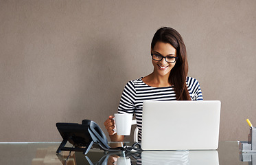 Image showing Laptop, tea and happy business woman in office for planning, management and checking email on wall background. Coffee, smile and female manager online for project, proposal or creative idea research