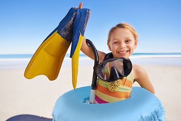 Image showing Beach, portrait and girl child with flippers, snorkel and inflatable swimming ring on ocean background. Face, happy and kid swimmer smiling, excited and ready for adventure while traveling in Miami