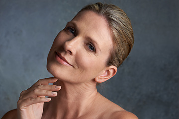 Image showing Portrait, beauty and woman with cosmetics, dermatology and salon treatment against a studio background. Face, mature female and person with morning routine, grooming and smooth skin with skincare
