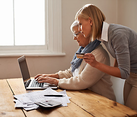 Image showing Senior mother, daughter and help with bills or taxes or calculator and debit card or table for savings and accounting at home. Finance, tax and pension or elderly woman or credit payment and pc